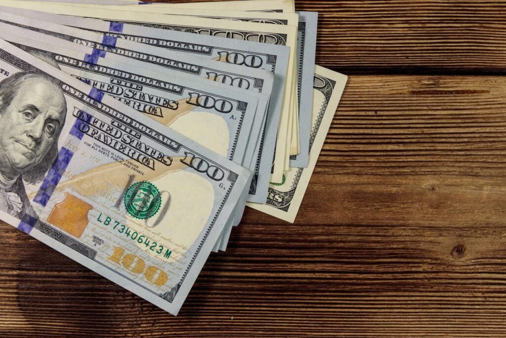 US dollar bills illustrating Florida property tax and relocating to Naples costs