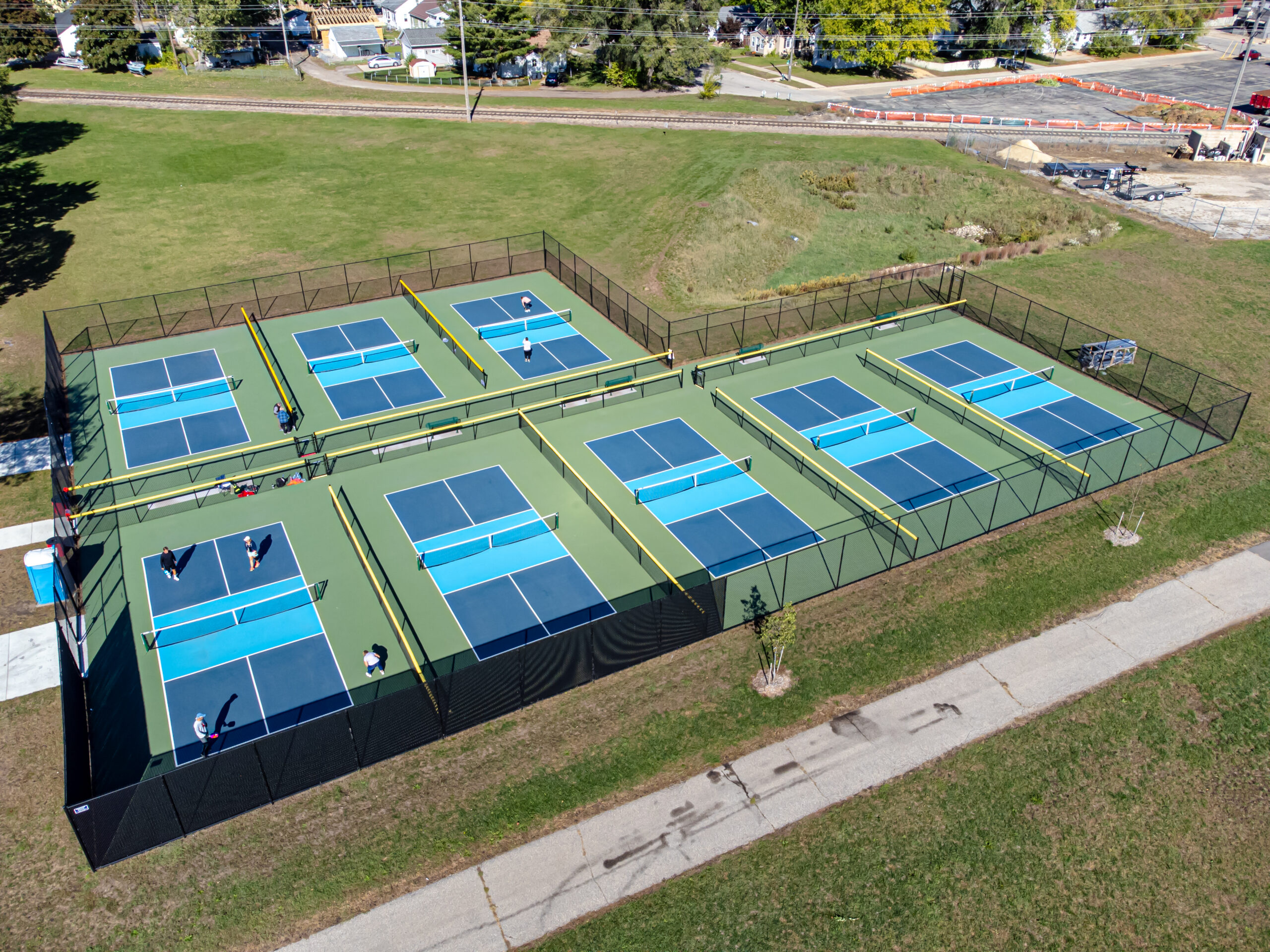 A pickleball court with net and court lines