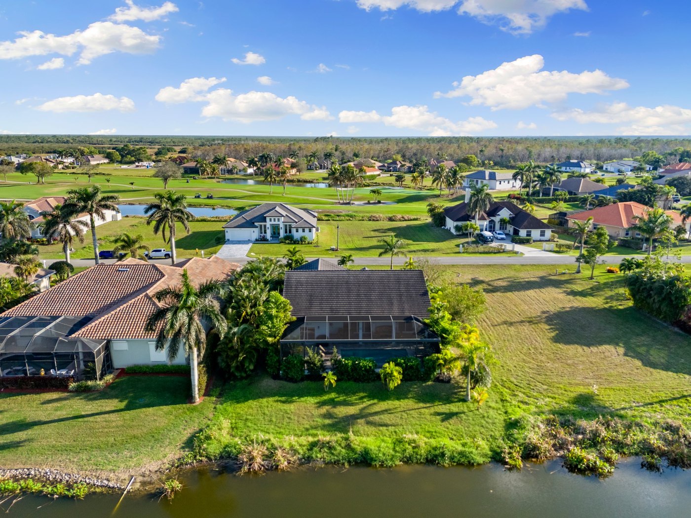 Aerial view of homes along a golf course and lakes in Royal Palm Golf Estates, Naples, Florida
